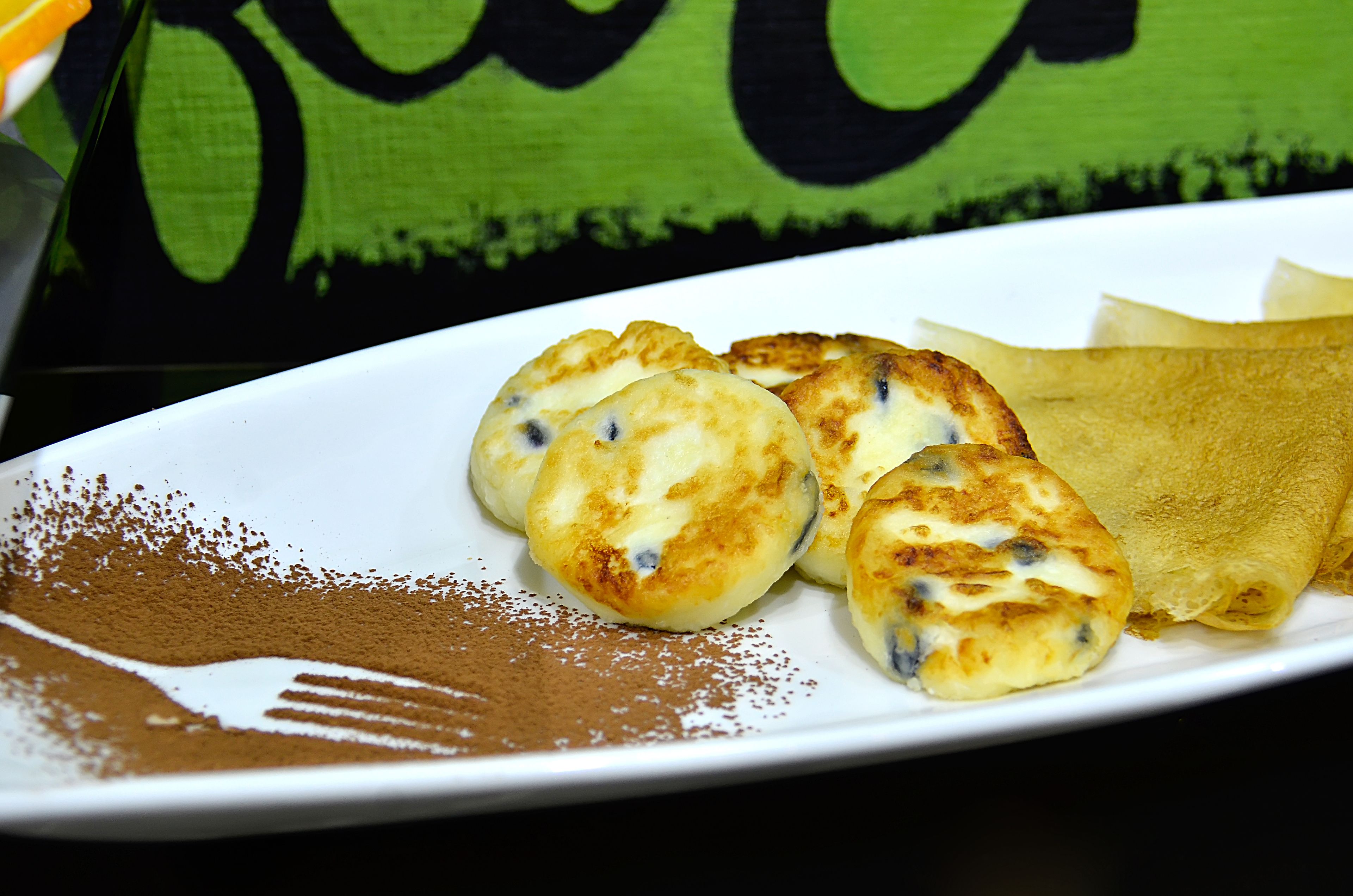 A plate with pastries and a dusting of cinnamon.