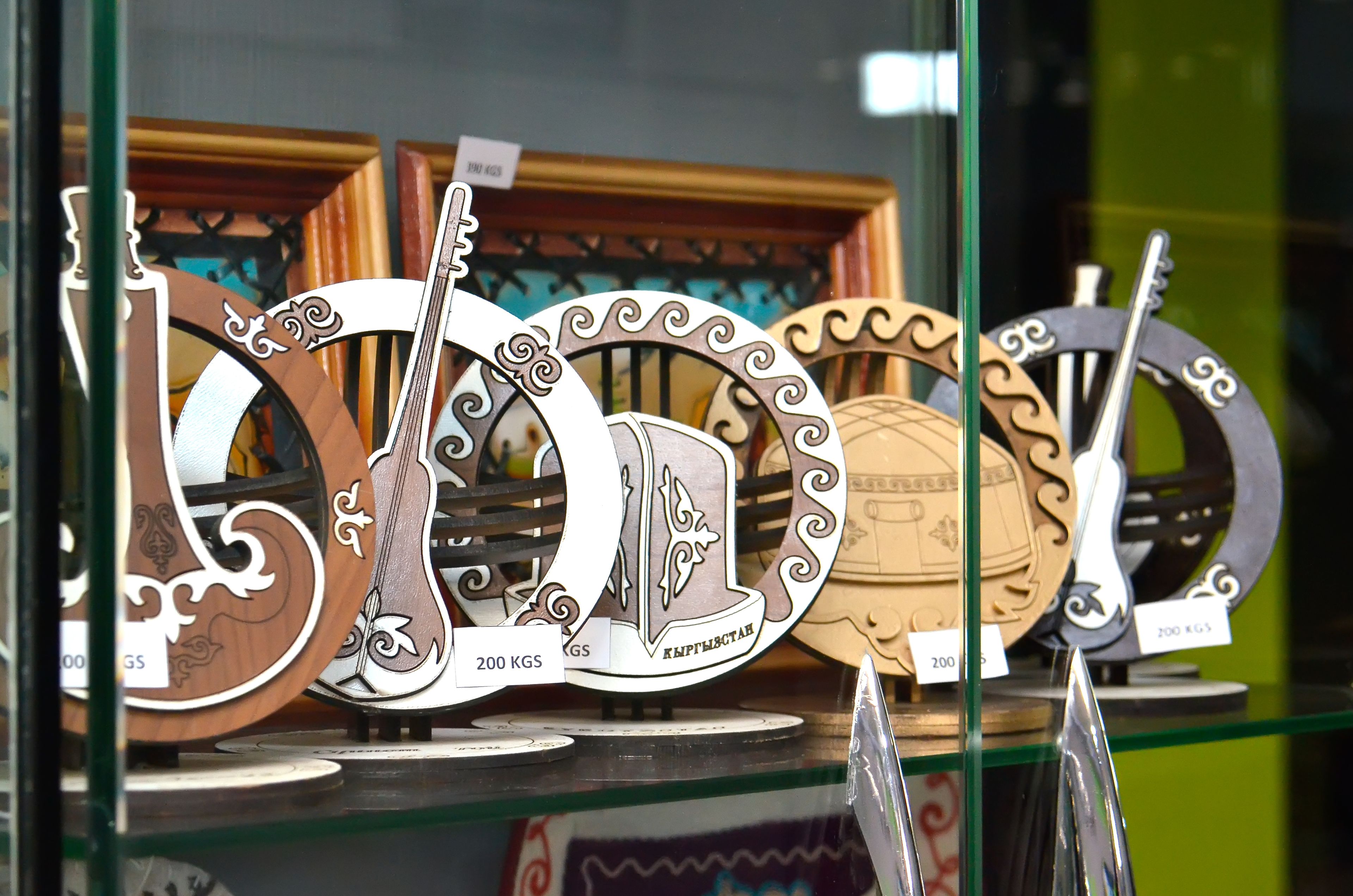 A display of decorative metal plaques with intricate designs, each labeled with a weight of 200 KGS.