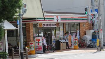 A 7-Eleven convenience store with a bicycle parked outside.