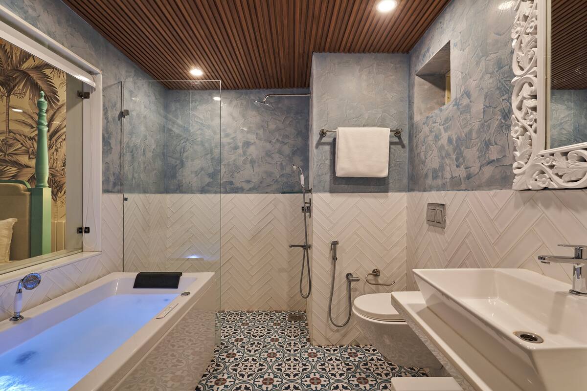 A modern bathroom with a freestanding bathtub, a shower area, and a sink.