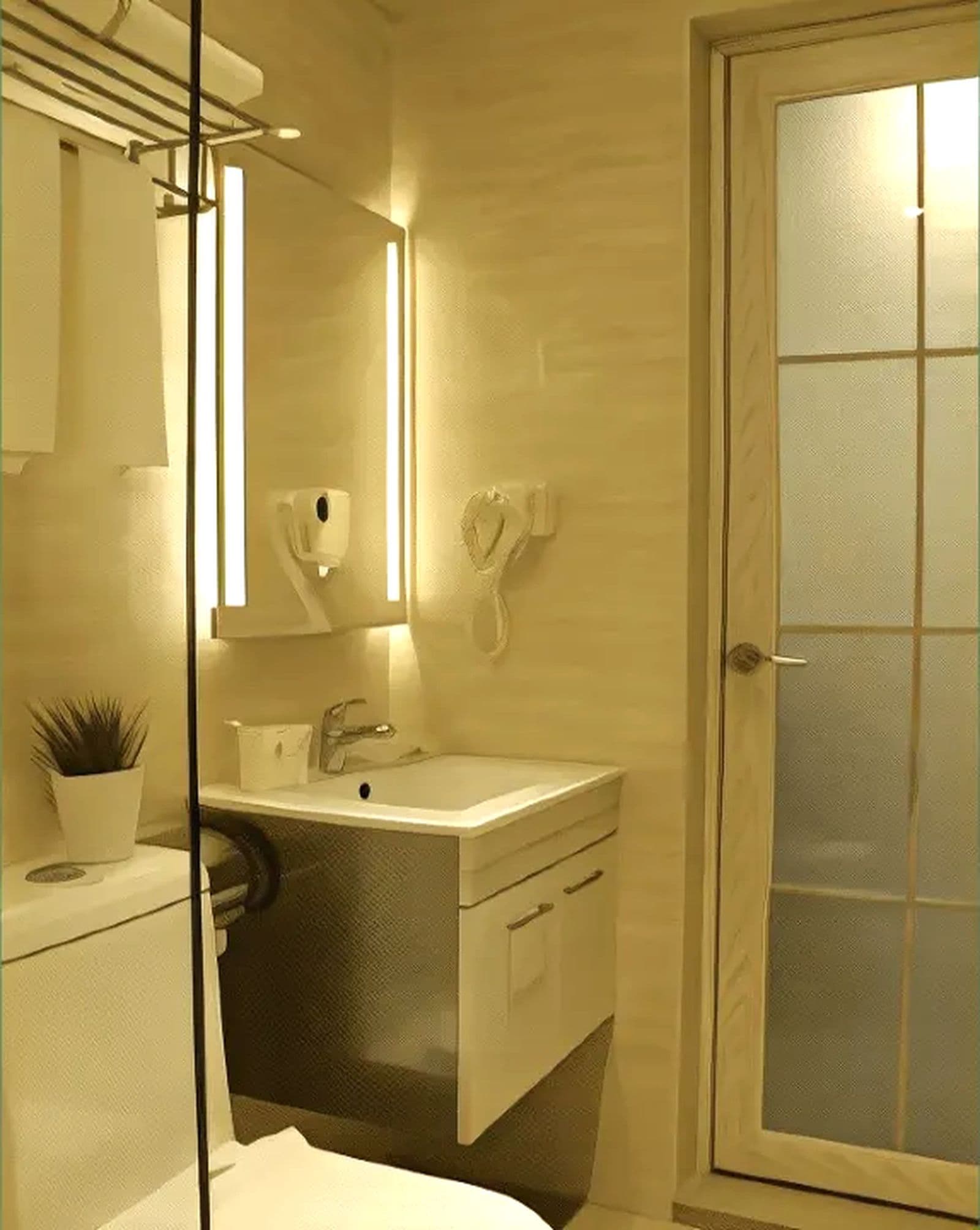 Un baño con lavamanos, espejo, toallero y una puerta con paneles de vidrio esmerilado.