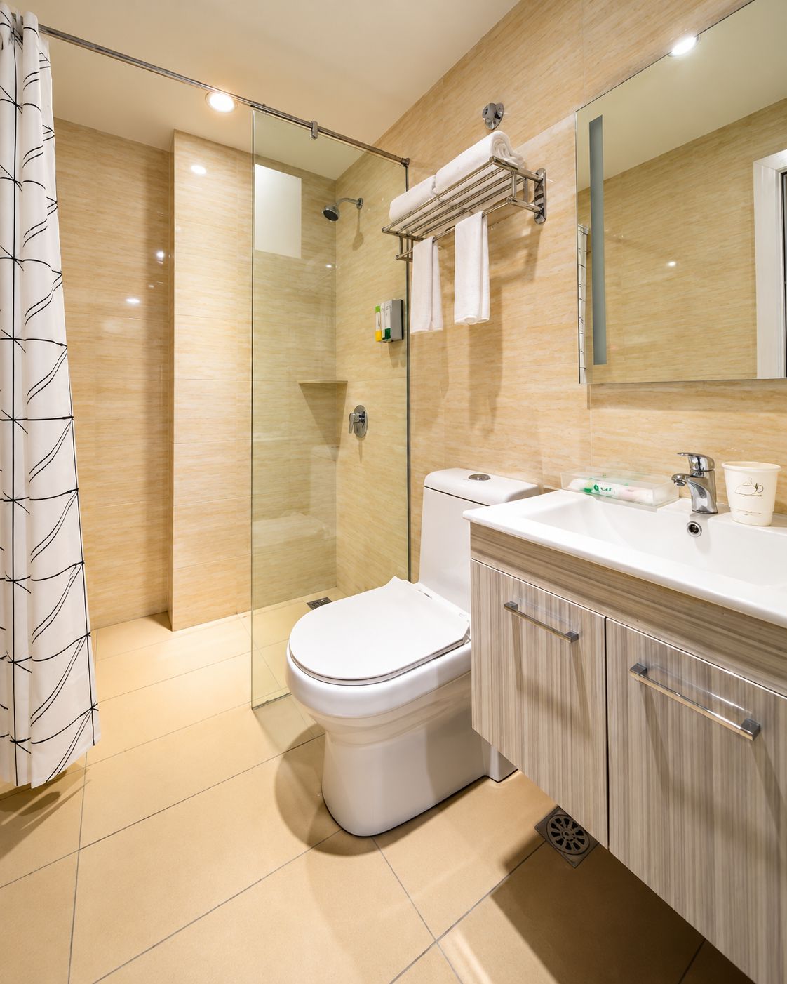 A modern bathroom with a glass-enclosed shower, a white toilet, and a vanity with a mirror.