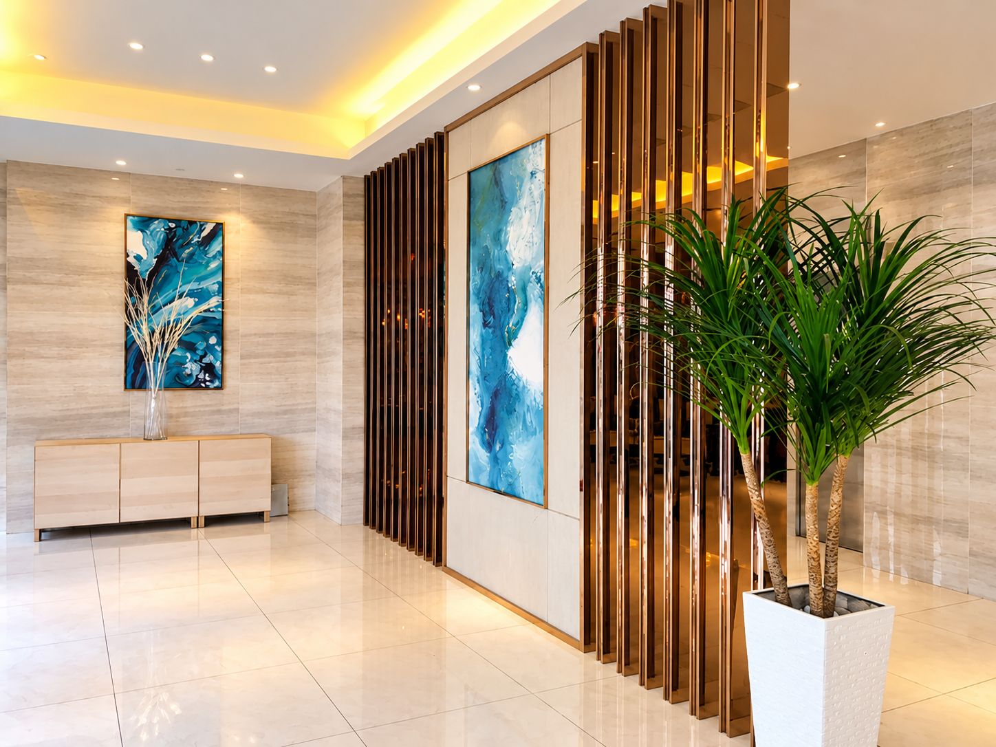 A modern lobby with a marble floor, a wooden reception desk, and a large abstract painting.