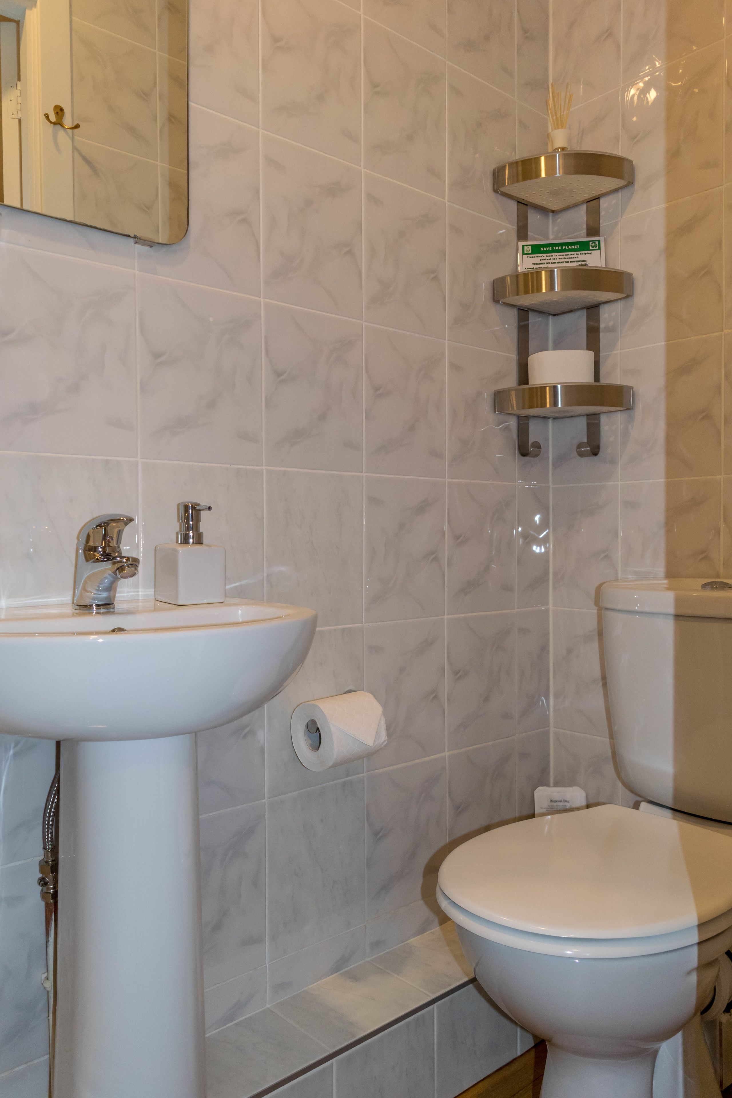 Ein Badezimmer mit Waschbecken, Toilette und Spiegel.