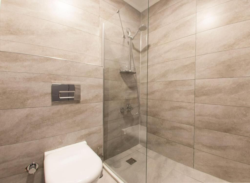 shower, hair dryer, slippers, towels