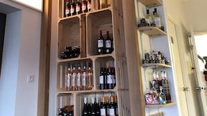 A wine cellar with wooden shelves holding various bottles of wine. - Fasthôtel Biarritz Bidart Côte Basque - FH Collection (Bidart)