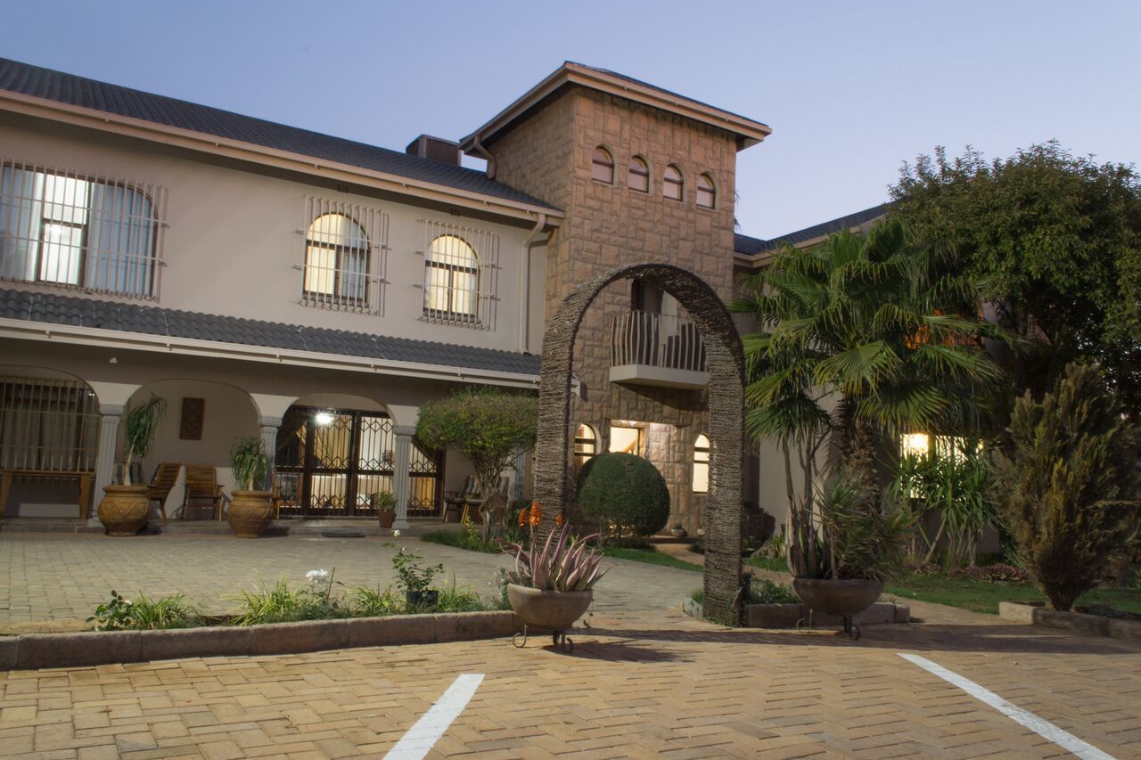 A building with a stone facade, large windows, and a central archway.