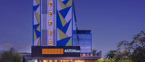 A modern hotel with a geometric facade, multiple windows, and a visible brand name.