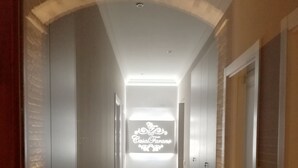 A long, narrow hallway with a modern design, featuring a central illuminated sign with the text "Casal Farano." - CasalFarano (Cupra Marittima)
