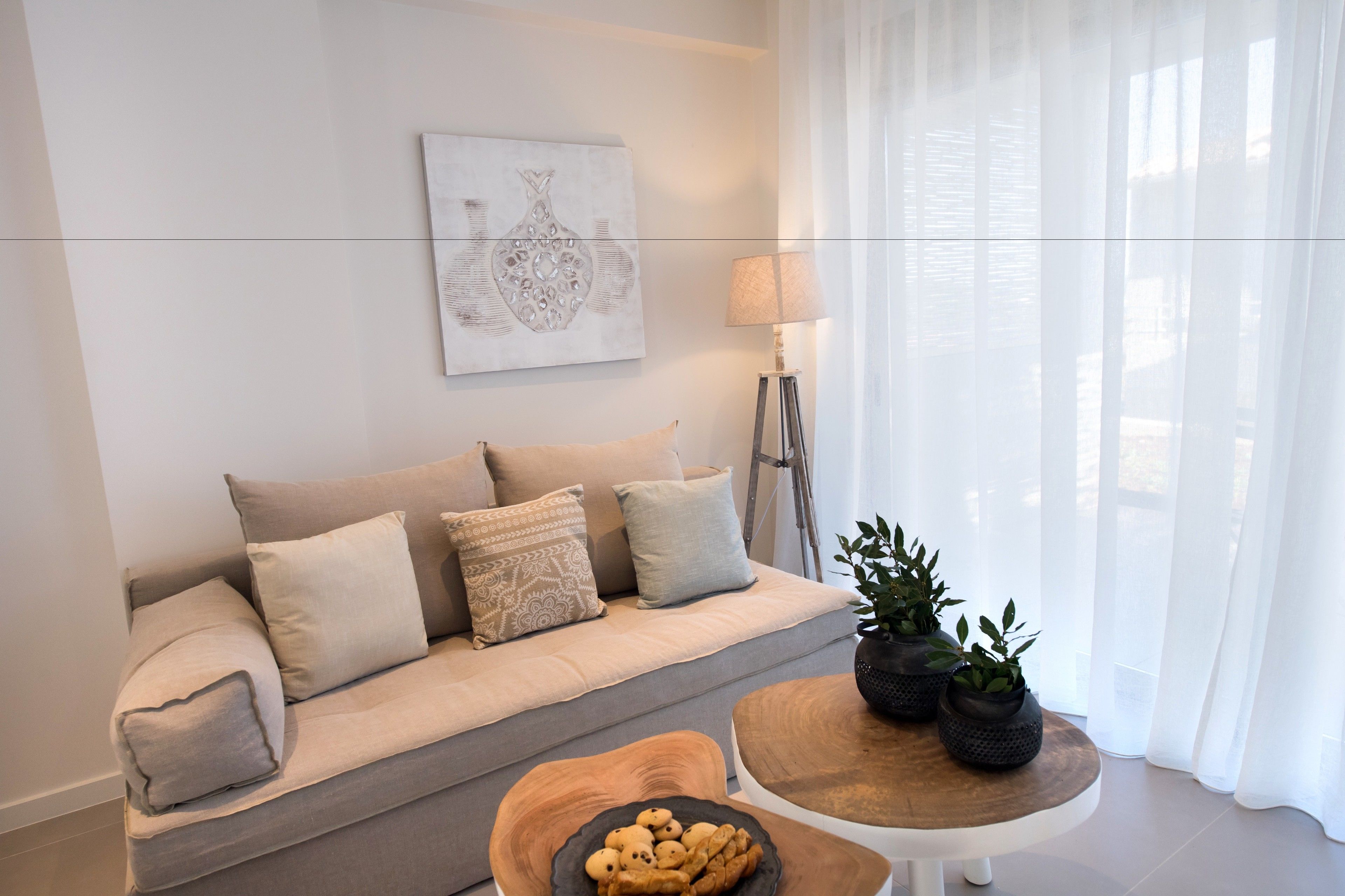A living room with a sofa, a coffee table, and a lamp.