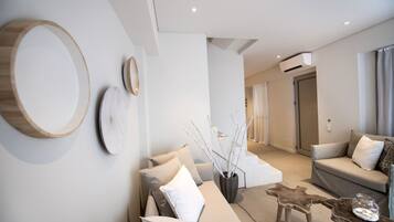 A modern living room with a sofa, coffee table, and decorative elements.