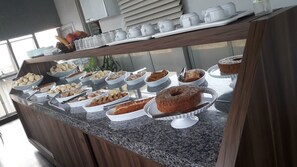 A buffet with various baked goods and pastries. - D'arc Hotel (Goiania)