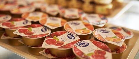 A display of packaged food items, likely yogurt, with labels indicating flavors such as strawberry and peach.