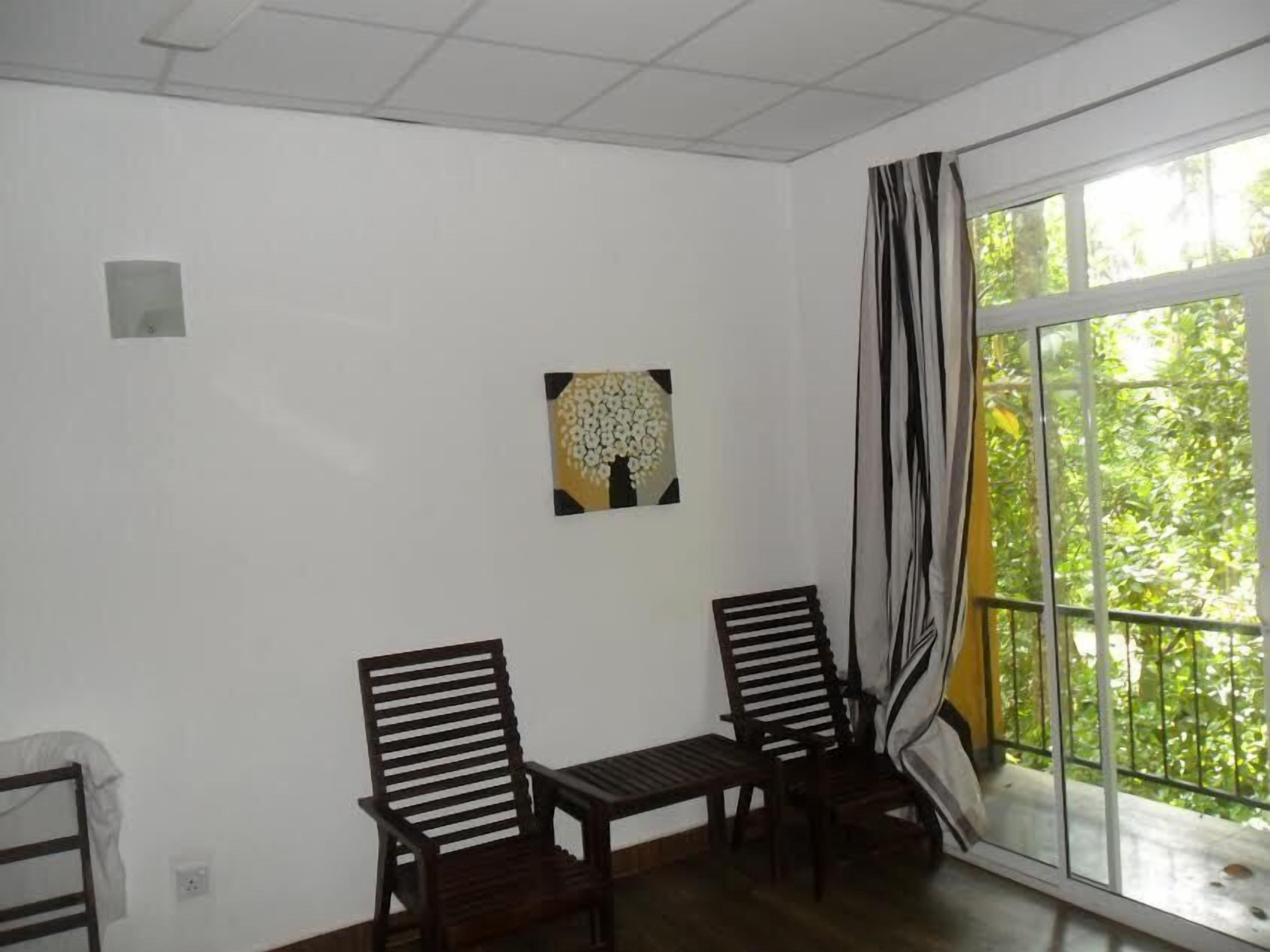 Economy Double Room Single Use, 1 King Bed, River View, Garden Area | Living area | Flat-screen TV