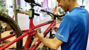 A person adjusting a bicycle's gear mechanism.