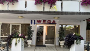 A hotel entrance with a sign reading "WEGA". - Hotel Wega (Bellaria-Igea Marina)