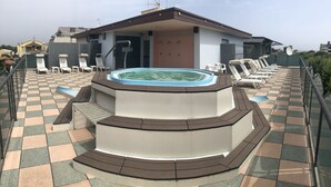 A rooftop pool area with a hot tub, lounge chairs, and a checkered floor. - Hotel Wega (Bellaria-Igea Marina)