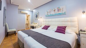 Una habitación de hotel con una cama grande, un escritorio, una silla y un baño.