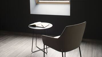 A room with a skylight, a table, and a chair.