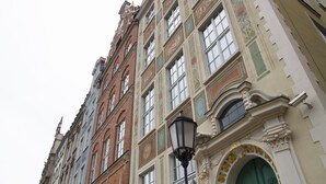 A multi-story building with ornate architectural details, including decorative moldings and a prominent arched entrance. - B&B HOTEL Gdańsk Old Town (Gdansk)