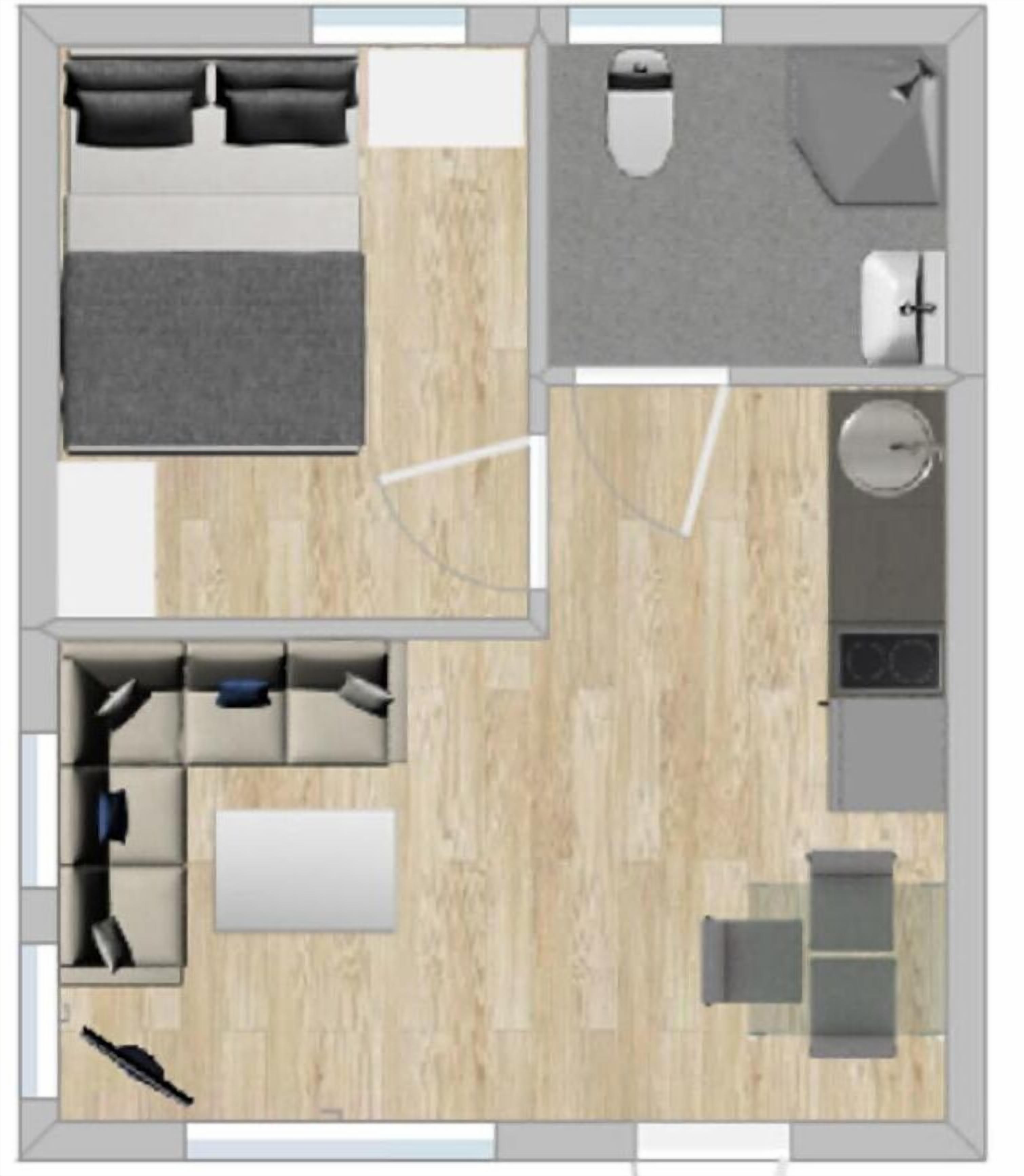 Plano de un cuarto de hotel con una cama, un escritorio, una silla, una mesita y un sofá.