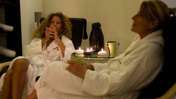 Guests can unwind in a serene spa setting with comfortable seating and soothing ambiance.
