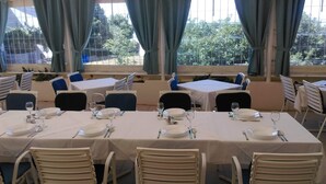 A dining area with tables set for four, each with plates, glasses, and cutlery. - Hotel Barba (Starigrad)
