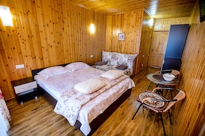 Cozy bedroom with a large bed, nightstands, and a reading nook.