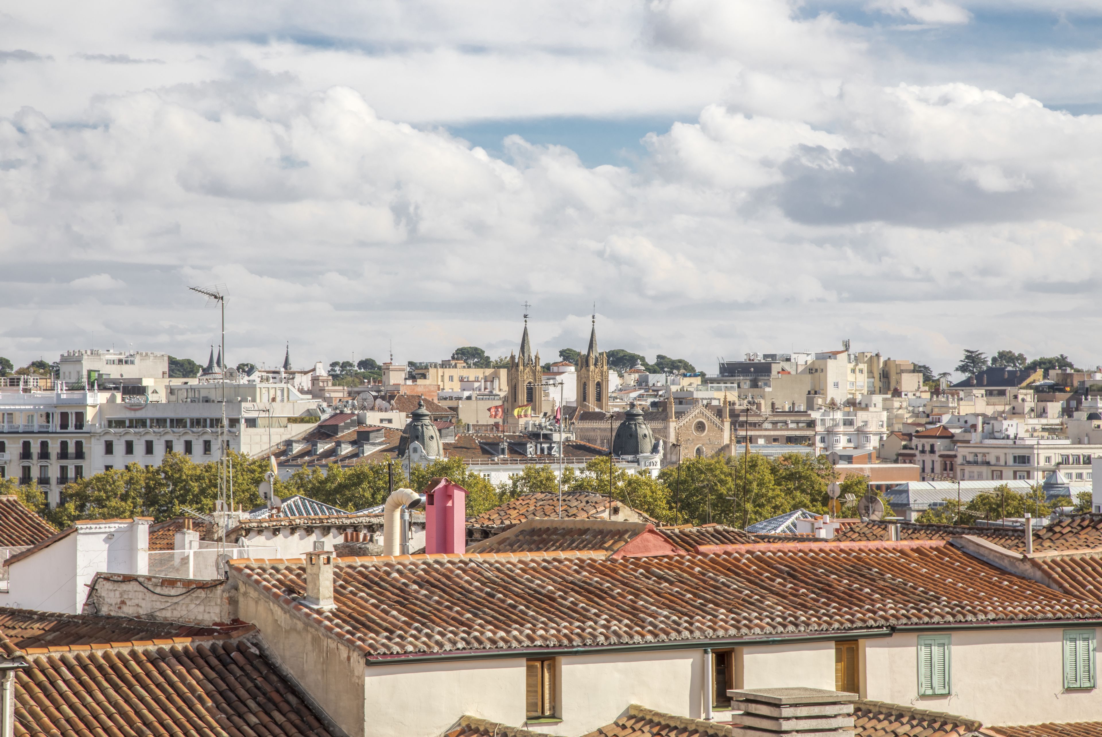 A cityscape with historic buildings and a prominent church spire.