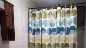 A bathroom with a toilet, sink, and shower curtain. - Depto Pedro Prado en Iquique 1119 (Iquique)