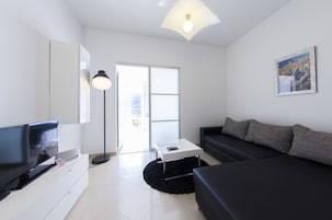 Premier Apartment, 1 Bedroom, Balcony, Sea View | Living area | Flat-screen TV