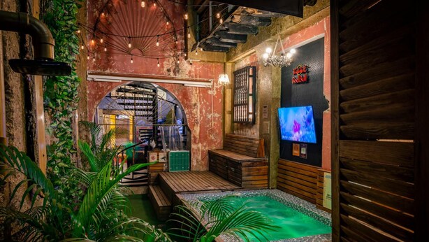 A spa area with a wooden deck, a small pool, and a Red Bull sign.