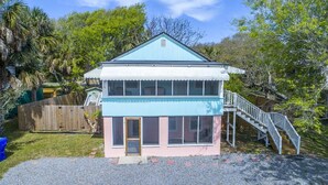 A two-story house with a blue exterior, a front porch, and a staircase leading to the second floor. - Short Walk to Shops, Restaurants & Beach Access,Pet Friendly, Private fenced in yard (Folly Beach)