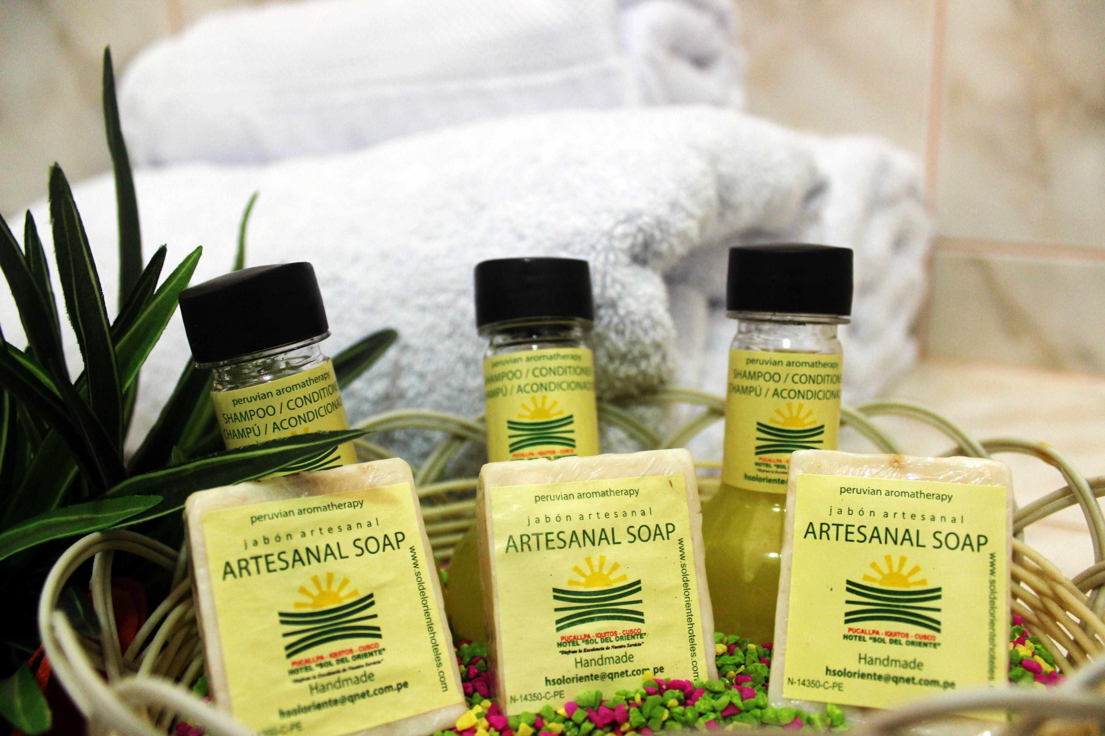 A display of artisanal soap products with labels indicating they are handmade and made with Peruvian aromatherapy.