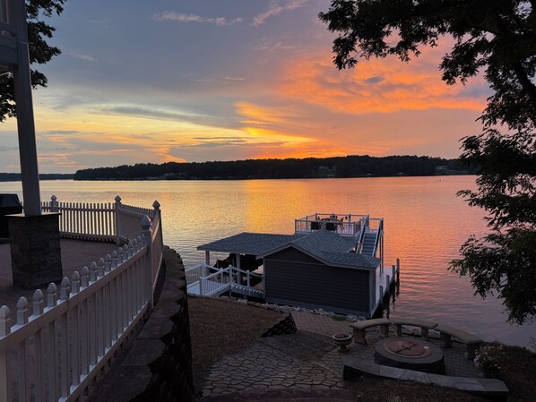 A lakeside view with a dock, a gazebo, and a stone pathway leading to a seating area. - Main Lake Luxury and spectacular panoramic views! Sleeps 8! (Macon)