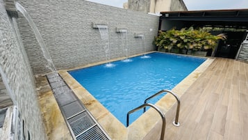 Outdoor pool, open 7:00 AM to 6:00 PM, pool loungers
