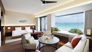 A hotel room with a bed, a sofa, a dining table, and a view of the ocean. - Hyatt Regency Seragaki Island Okinawa (Onna)