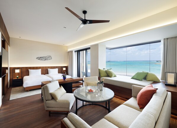 A hotel room with a bed, a sofa, a dining table, and a view of the ocean. - Hyatt Regency Seragaki Island Okinawa (Onna)