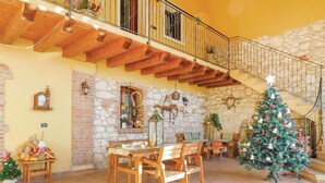 A cozy interior with a wooden dining table, chairs, a Christmas tree, and a staircase leading to an upper level. - Beautiful apartment in Longare -VI- with WiFi (Longare -VI-)