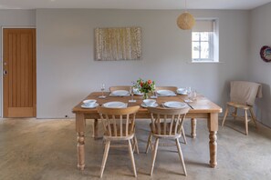A dining room with a wooden table set for four, surrounded by four wooden chairs. - The Parlour, Freston (Freston)
