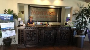 A reception desk with a sign reading "Monte Vista Resort".