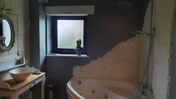 Bathtub, hair dryer, towels, toilet paper