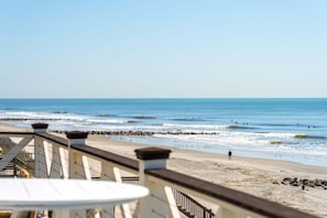 A beach view with a wooden deck, a sandy beach, and the ocean. - 6 BR + Bonus Room, Luxury Oceanfront, Pets ok, Elevator, 2 Living Rooms - The Loggerhead (Folly Beach)