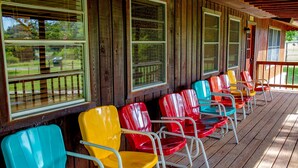 A covered porch with rows of colorful plastic chairs. - Panoramic Country Views ~ Wildlife ~ Butterflies & Birds ~ Star-gazing ~ Hiking (Leakey)