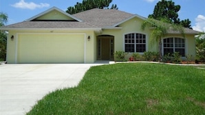 A single-story house with a garage, a front porch, and a small attached garage. - 3 Bedroom Home with Heated Private Pool Close to Golf & Beach (Rotonda lakes)