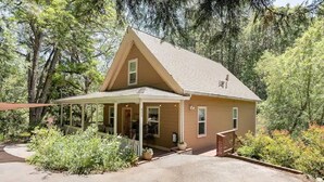 A single-story house with a gabled roof, a covered porch, and a driveway.
