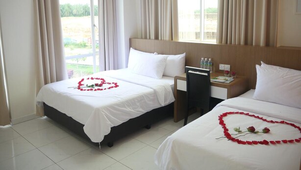 A hotel room with two beds, each adorned with a heart made of rose petals. - Hotel Wawasan (Simpang Renggam)