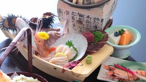 A variety of seafood including shrimp, scallops, and lobster arranged on a wooden tray. - Umisanpo (Ofunato)
