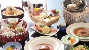 A variety of seafood dishes arranged on a table. - Umisanpo (Ofunato)
