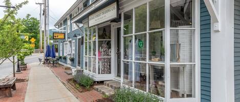A storefront with a sign reading "Bridge Street Trading Co." and a "Peasant" sign above it.